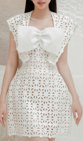 Chic White Laser-Cut Mini Dress with Oversized Bow Detail
