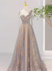Hermoso vestido formal largo con escote en V y cordones en color champán y gris