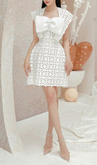 Chic White Laser-Cut Mini Dress with Oversized Bow Detail