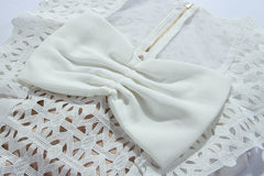 Chic White Laser-Cut Mini Dress with Oversized Bow Detail