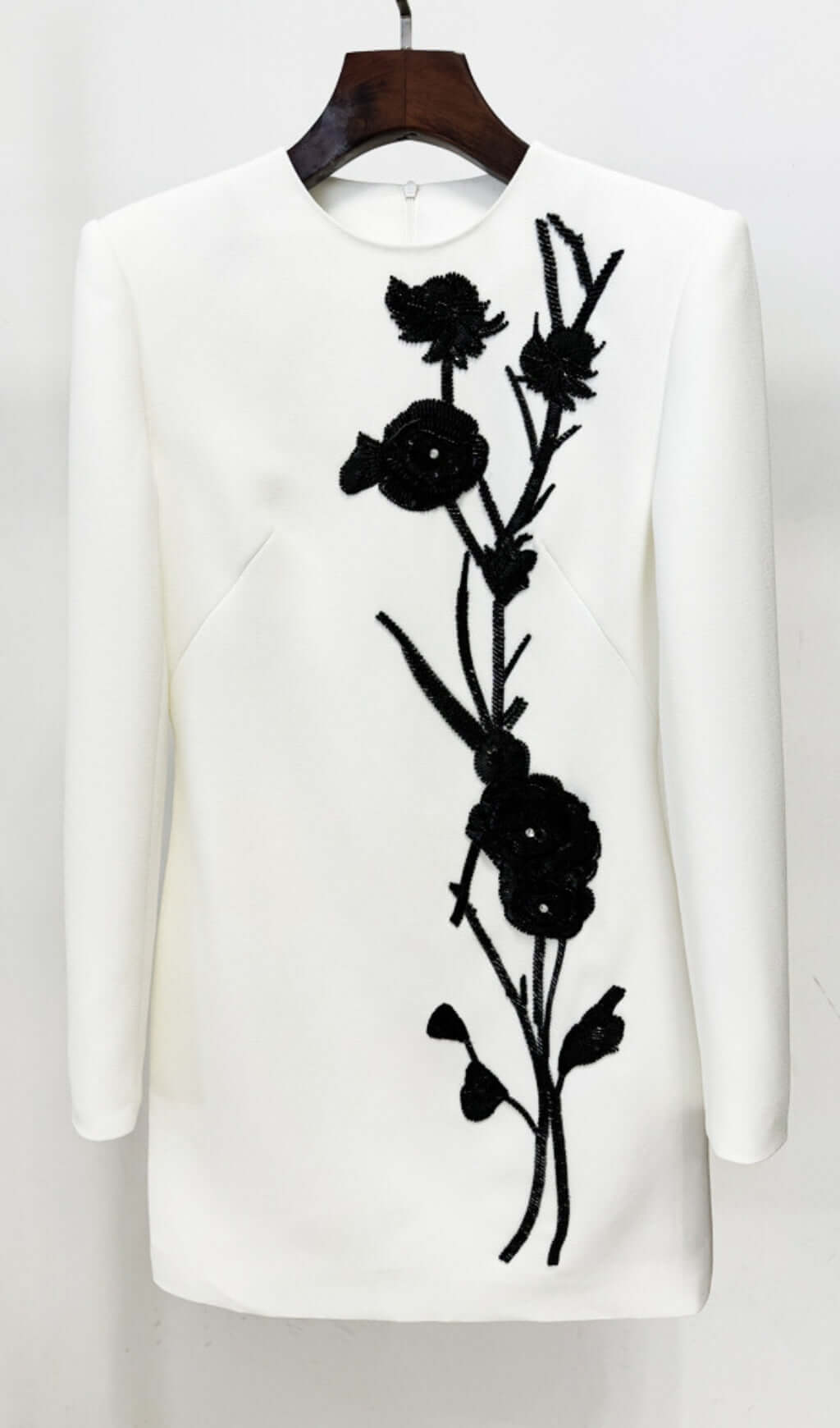 Chic White Long Sleeve Mini Dress with Black Floral Embellishment