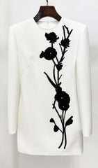 Chic White Long Sleeve Mini Dress with Black Floral Embellishment