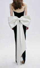Elegant Black Strapless Bustier Maxi Gown with Dramatic White Bow Back