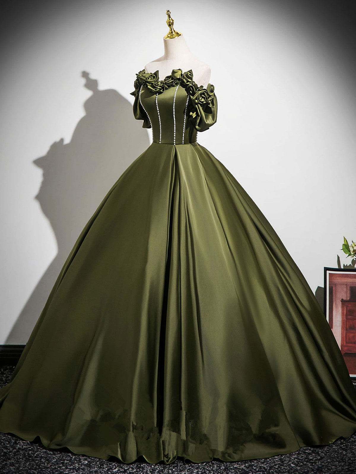 Vestido de fiesta verde con hombros descubiertos, cuentas y flores hasta el suelo 